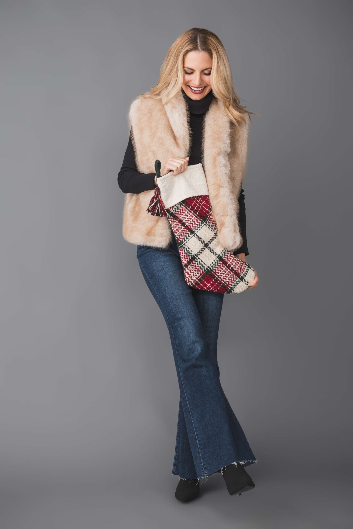 Faux fur vest in light beige with fluffy texture, sleeveless design, and open front
