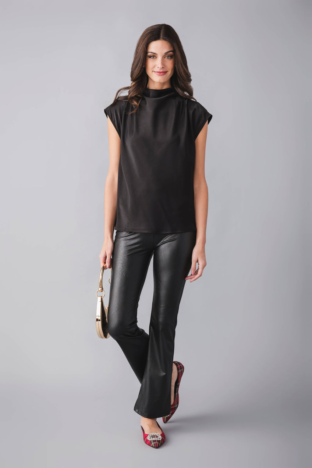 Black draped high-neck sleeveless top, high collar and soft drape