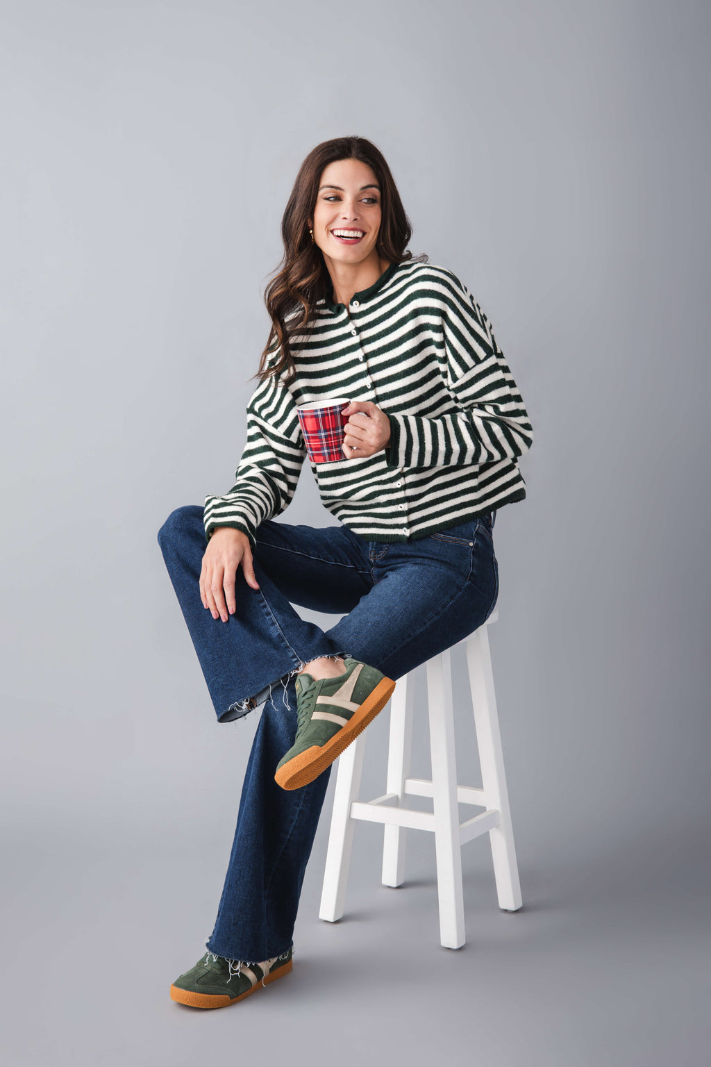 Green and white striped button-front cardigan with long sleeves and crew neck