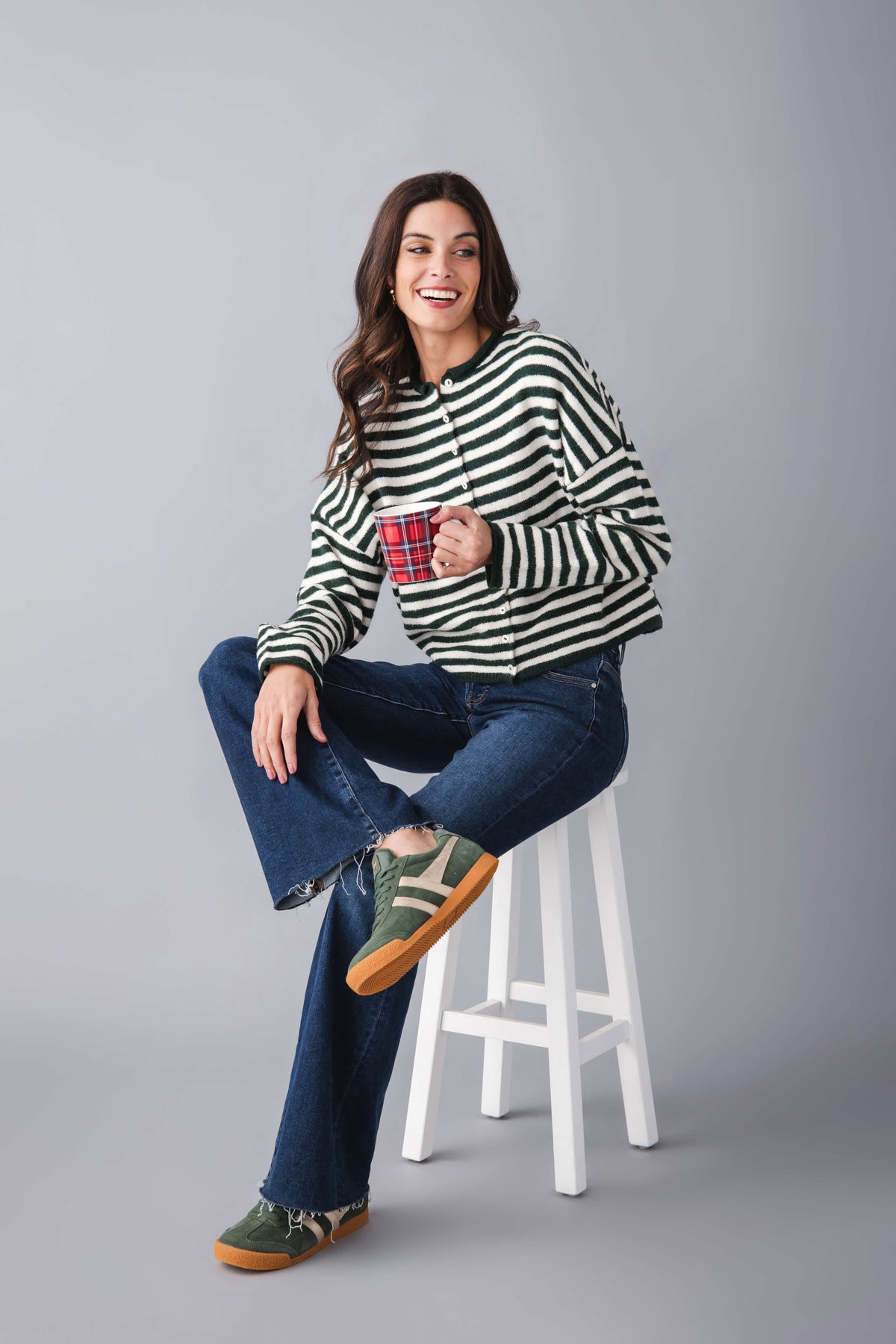 Green and white striped button-front cardigan with long sleeves and crew neck