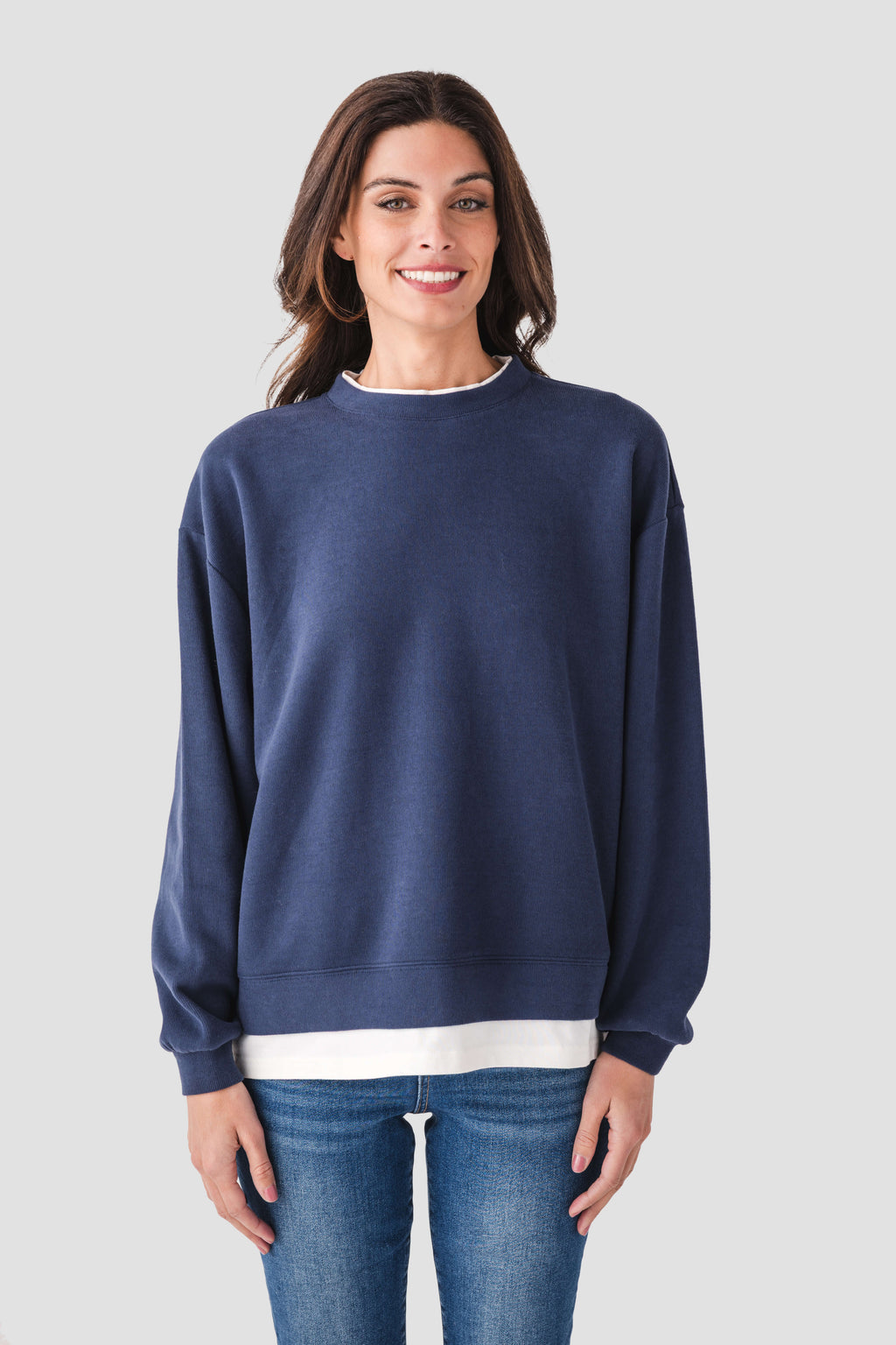 Blue crewneck pullover with ribbed cuffs and hem, white trim across the bottom edge