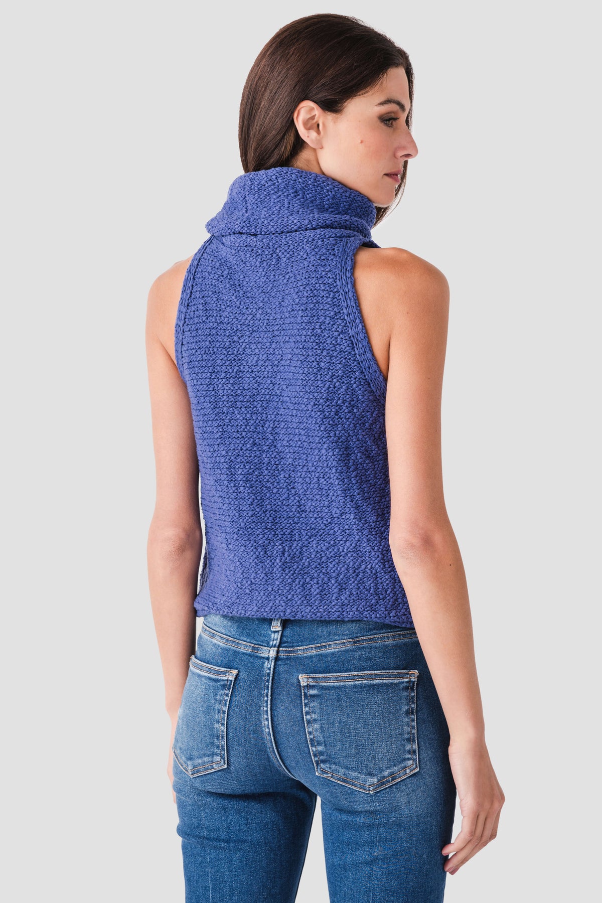 Blue sleeveless textured knit top with high cowl neckline, side view