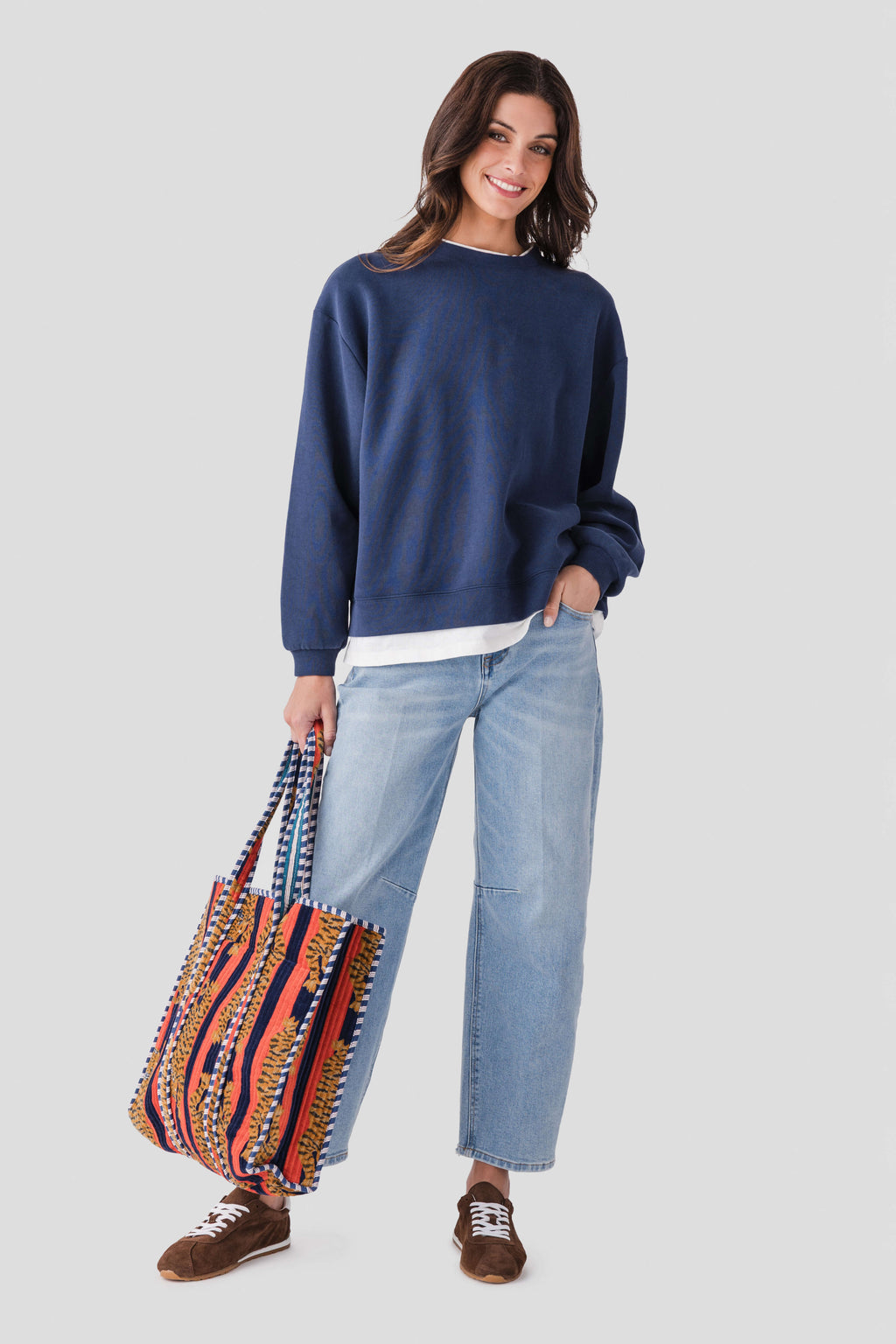 Navy crewneck pullover with ribbed cuffs and hem, relaxed fit, white trim at bottom