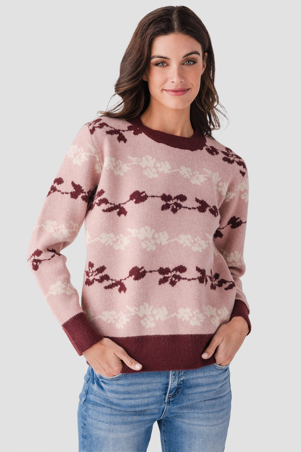 Floral jacquard knit pullover in mute rose with maroon bow stripe pattern, ribbed cuffs