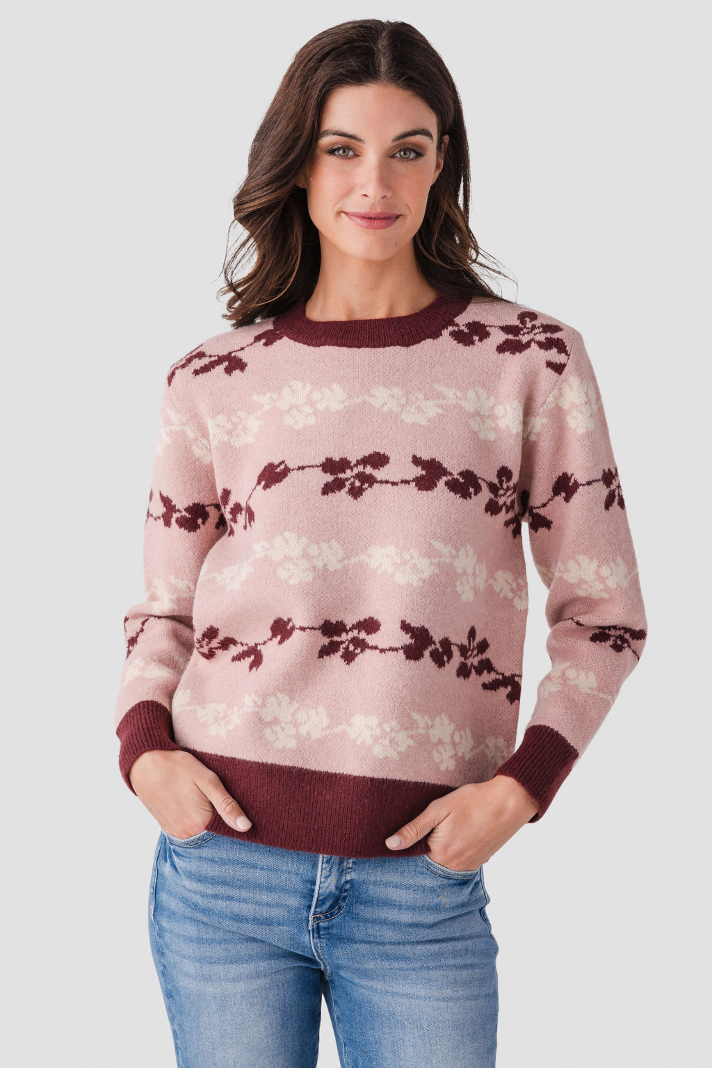 Floral jacquard knit pullover in mute rose with maroon bow stripe pattern and crewneck