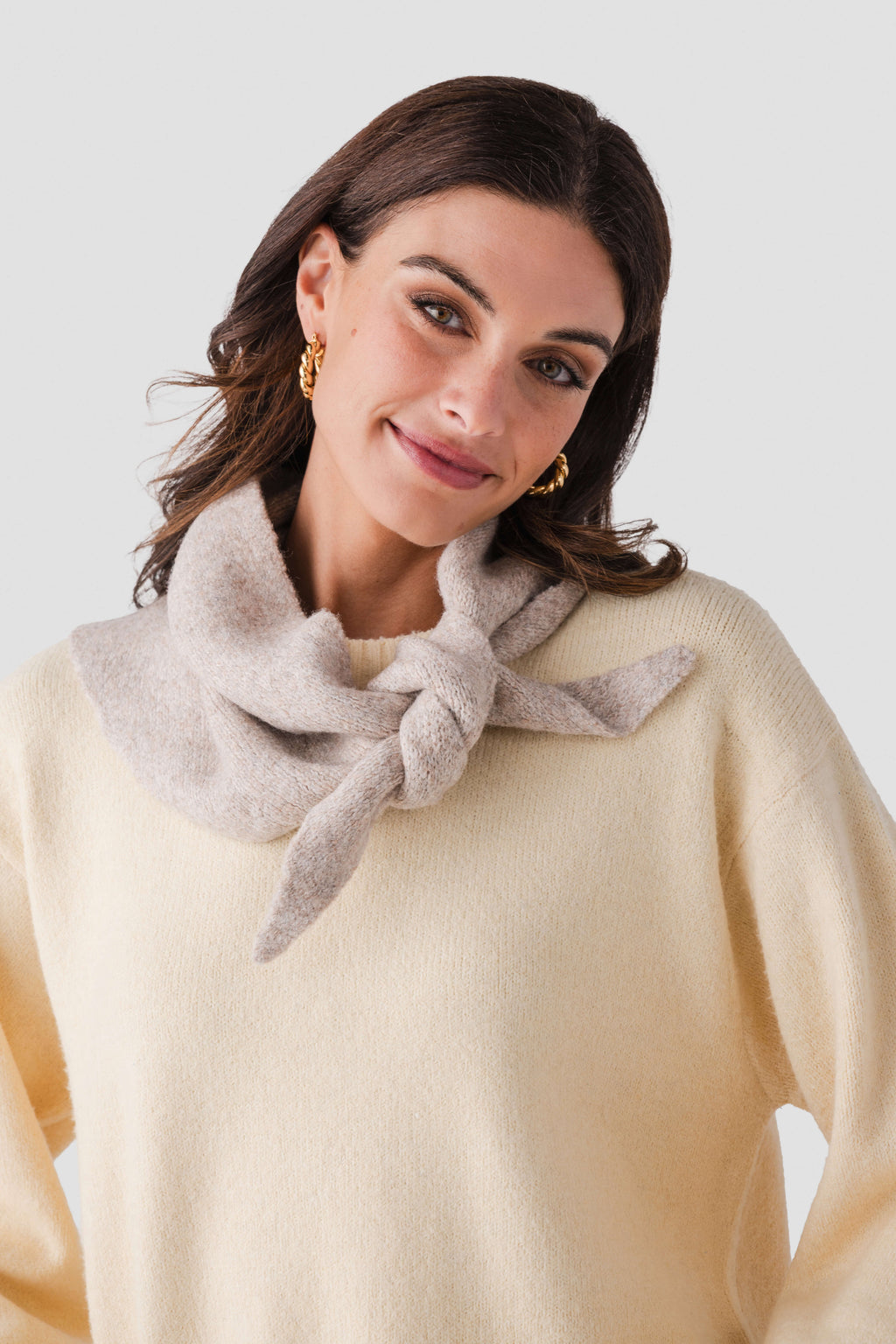 Light gray wool triangle scarf with loose knot at the front