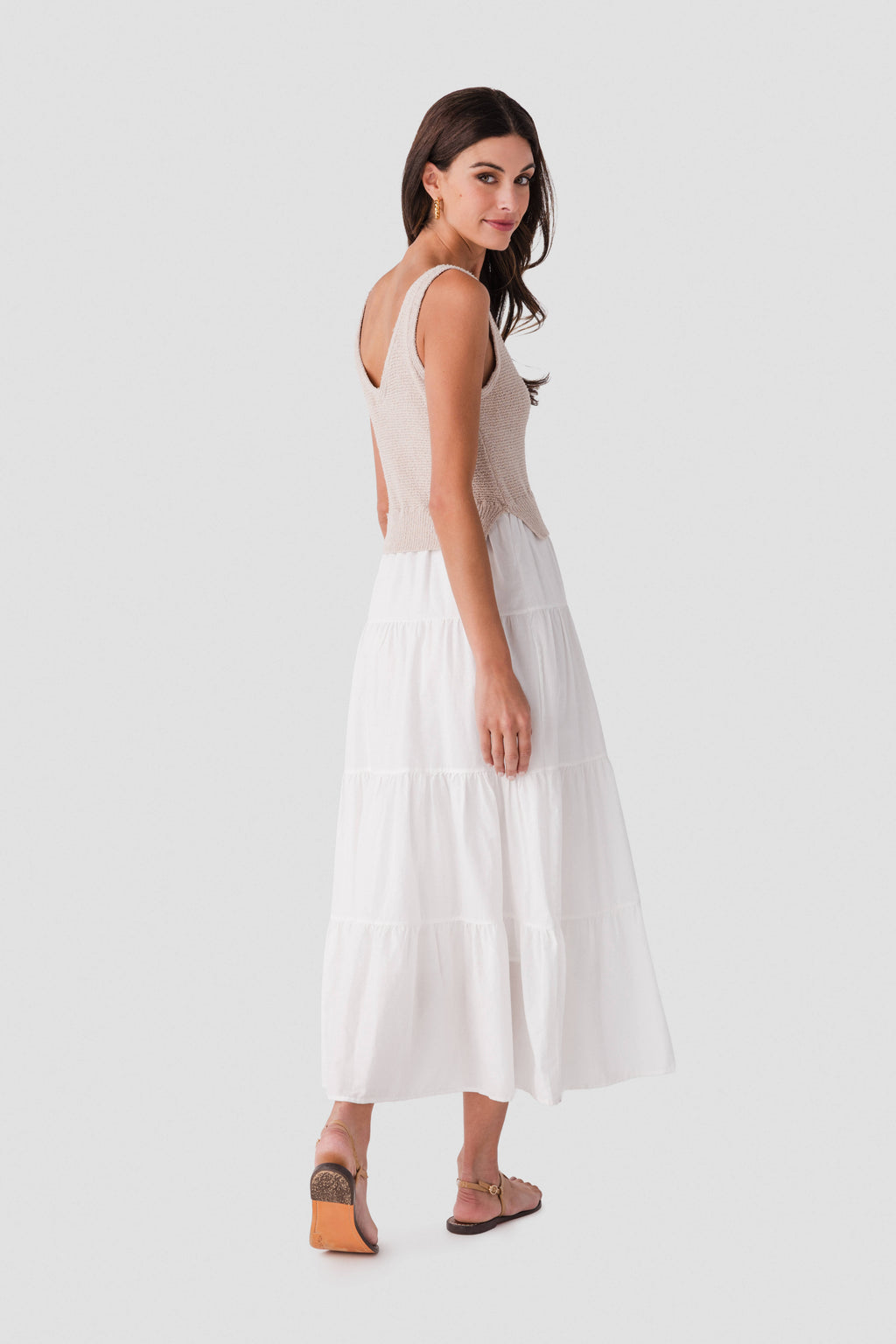 Side view of light sleeveless maxi dress with scoop neck and tiered skirt