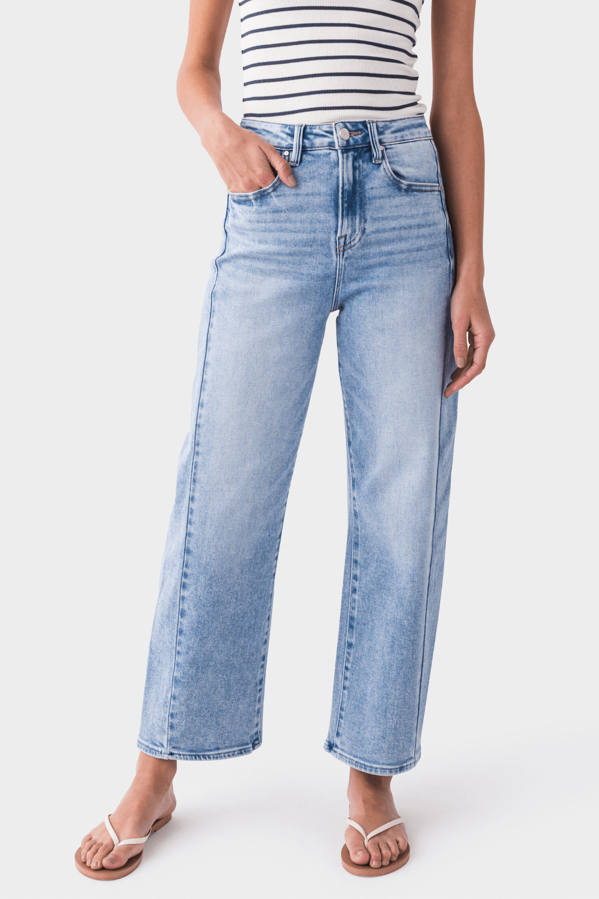 High-rise barrel jeans in medium light blue wash with whiskering and belt loops