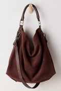 Dark brown suede slouch tote with two handles and adjustable crossbody strap, open top