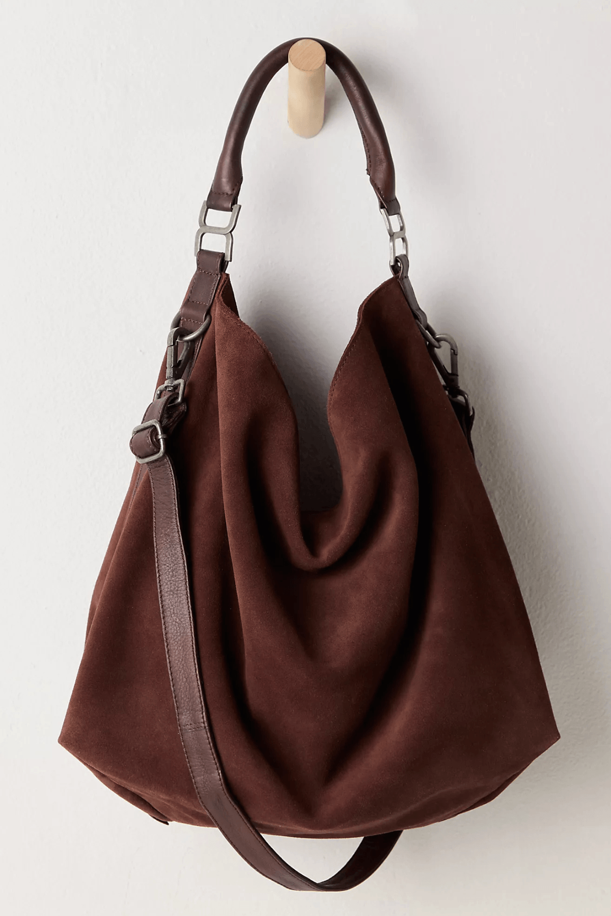 Dark brown suede slouch tote with two handles and adjustable crossbody strap, open top
