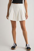 White pleated tennis-style skirt with elastic waistband and flared A-line hem.