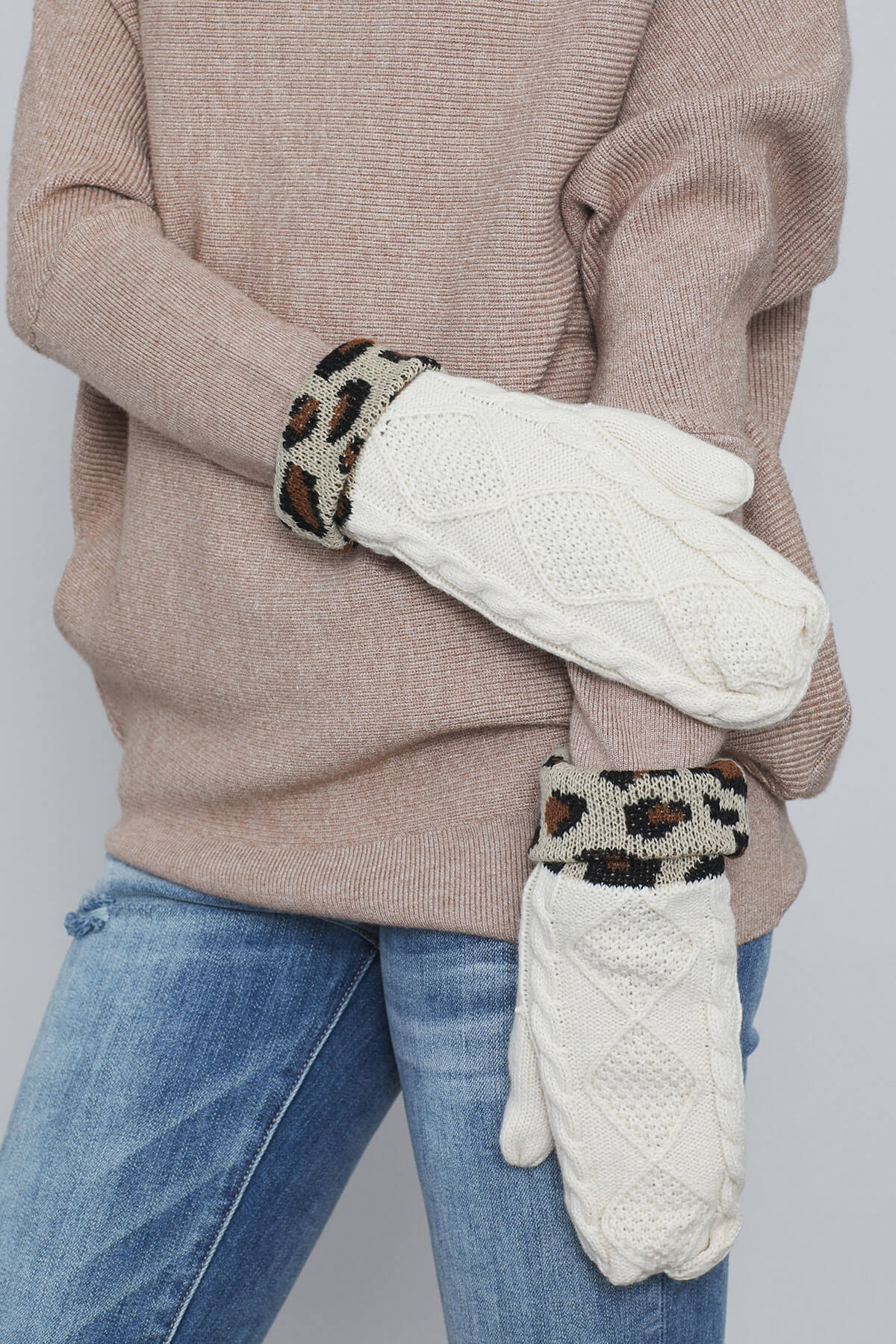 Ivory cable knit mittens with leopard-pattern cuffs and textured thumb