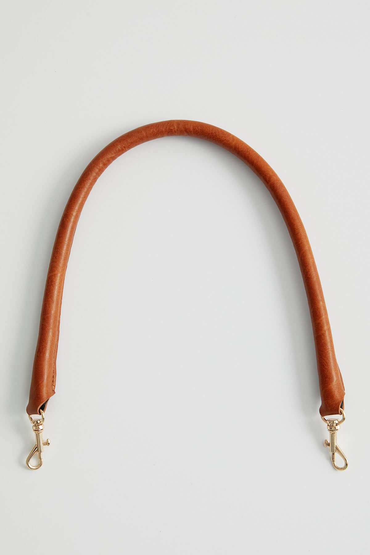 Brown tube strap with metal lobster clasps, curved ends for bag attachment