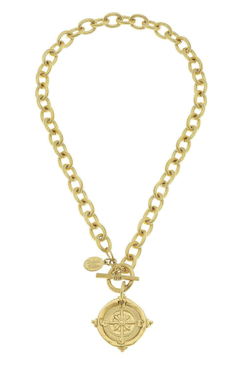Gold toggle necklace with curb chain and compass medallion pendant