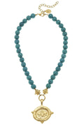 Turquoise bead necklace with gold-tone bee locket pendant and chain clasp